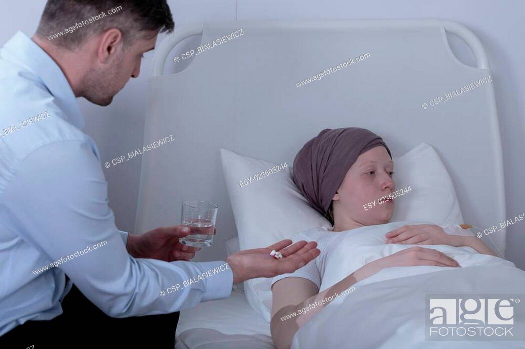 Stock Photo: Father giving ill daughter medicines.