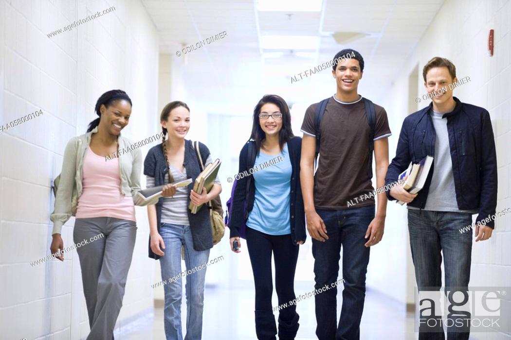 Stock Photo: High school students walking down school corridor.