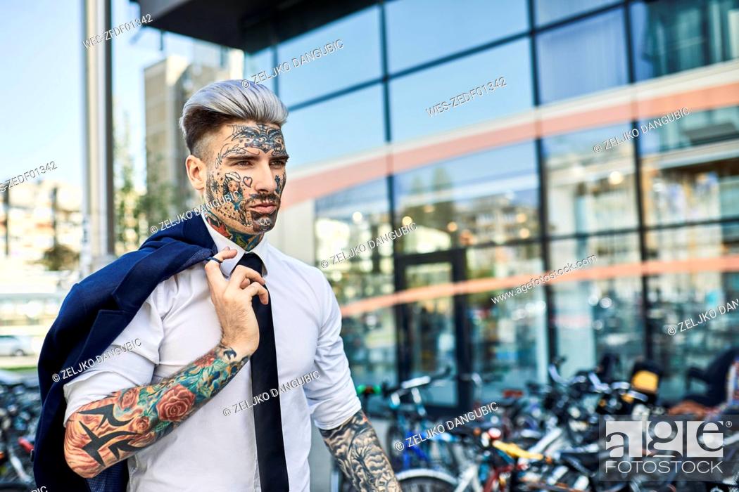 Young businessman with tattooed face walking in the city, portrait, Stock  Photo, Picture And Royalty Free Image. Pic. WES-ZEDF01342 | agefotostock