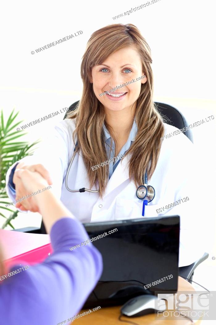 Stock Photo: Smiling female doctor shaking a hand in her office.