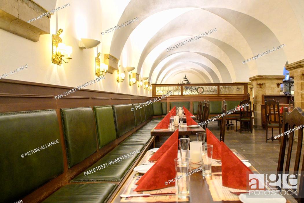 Stock Photo: 20 May 2021, Saxony-Anhalt, Magdeburg: Empty but already set tables in the historic restaurant ""Ratskeller"". Where the federal emergency brake no longer.