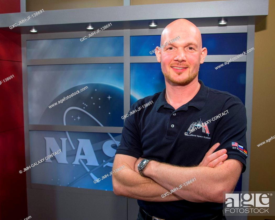 Stock Photo: Alexander Gerst, Expedition 4041 flight engineer representing the European Space Agency, poses for photographs following a March 18 press conference at NASA's.
