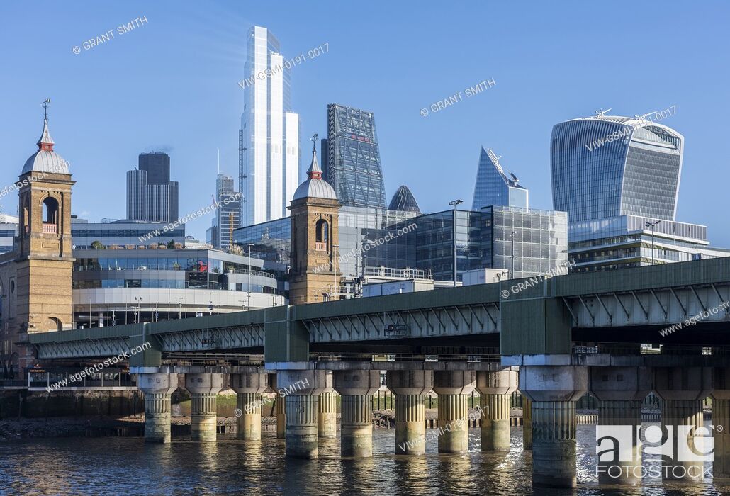 Stock Photo: View to the City looking north east from Southwark on a bright blue sky day. Cannon Street railway bridge cuts the frame.