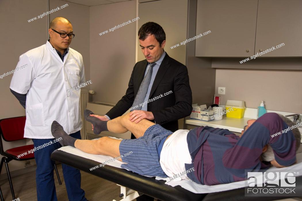Stock Photo: Reportage in Nollet Clinic in Paris, France. Post-op consultation (hip replacement) with Dr Nogier, a hip surgeon. Flexing the hip.