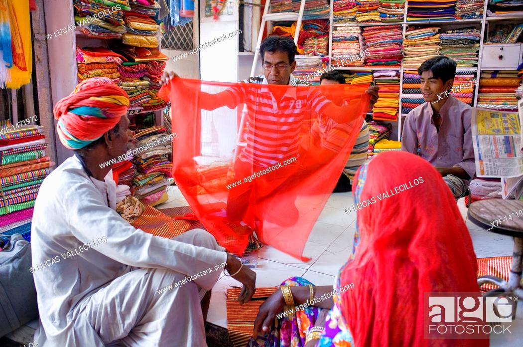 Stock Photo: Vendor and customer in Clothing store, Sardar Market, Jodhpur, Rajasthan, India.
