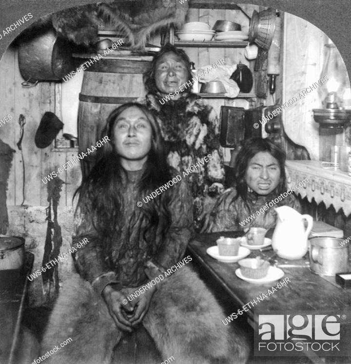 Stock Photo: Fort Magnesia, Cape Sabine, Ellesmere Land, Canada: c. 1900.An Eskimo family poses in its home.