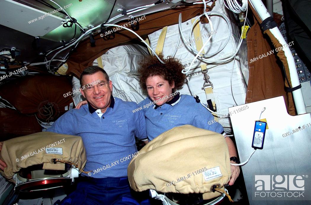 Stock Photo: Astronauts James S. Voss and Susan J. Helms, STS-102 mission specialists, are pictured with supplies on the mid deck. The two astronauts are assigned to space.