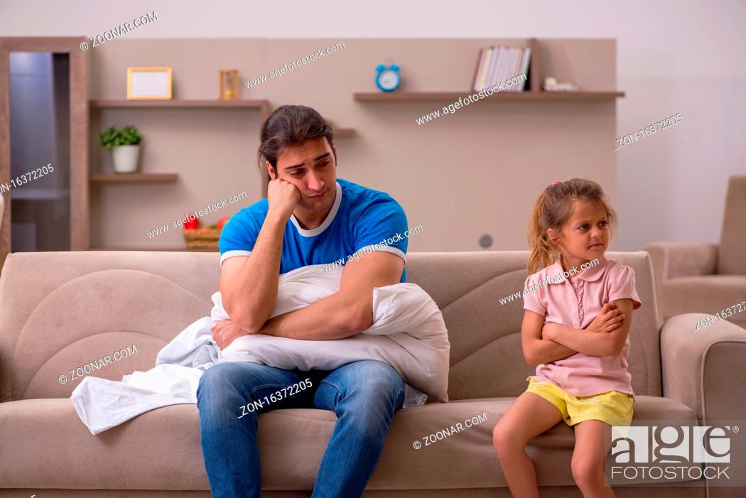 Stock Photo: Young man with his small daughter at home.