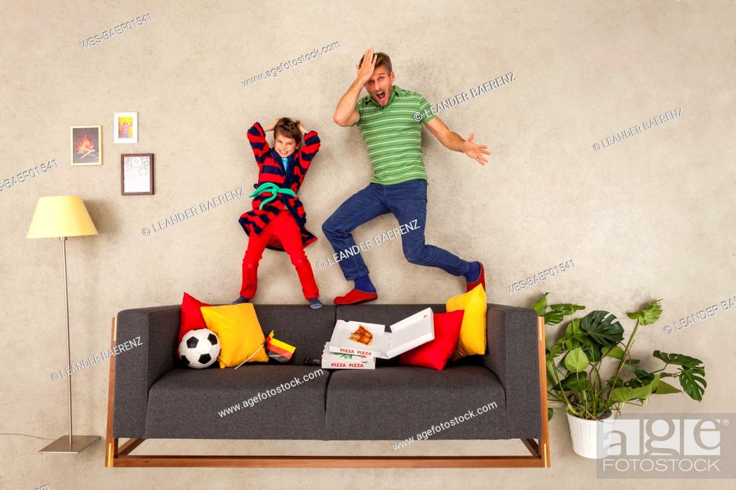 Stock Photo: Father and son watching soccer together.