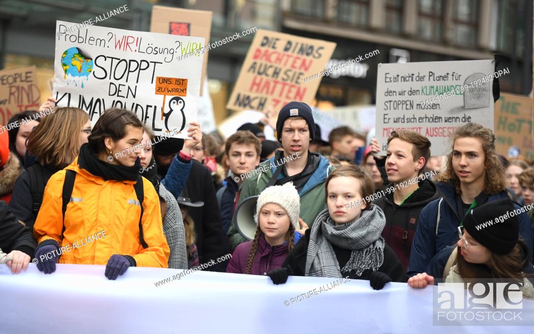 Stock Photo: 01 March 2019, Hamburg: Climate activist Greta Thunberg (M) at a rally. The young Swedish woman has come to Germany for the first time for a school strike for.