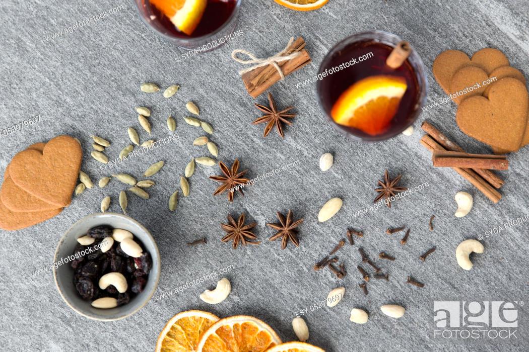 Stock Photo: hot mulled wine, orange slices, raisins and spices.
