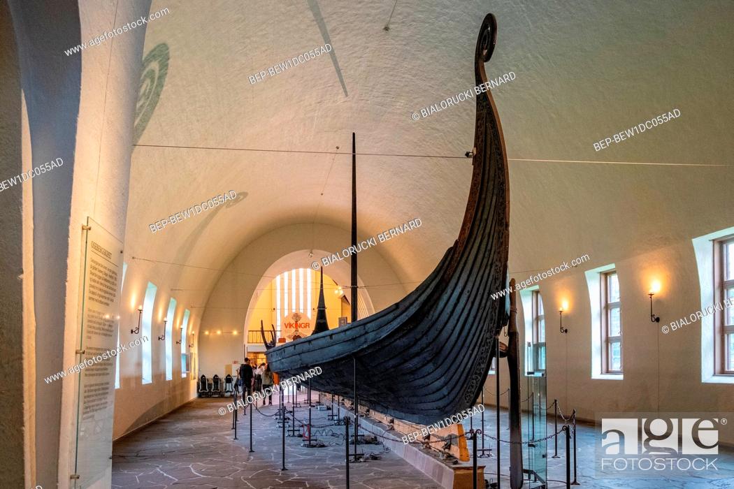Stock Photo: Oslo, Ostlandet / Norway - 2019/08/31: Oseberg ship excavated from ship burial archeological site, exhibited in Viking Ship Museum on Bygdoy peninsula of Oslo.
