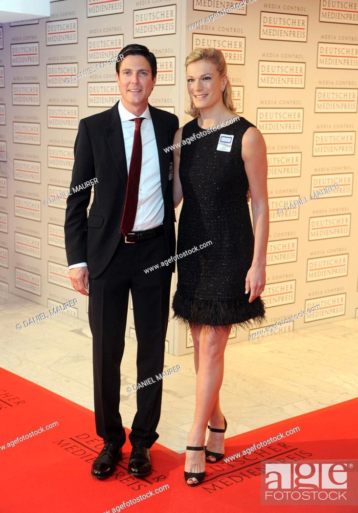 Stock Photo: Olympic skiing gold medalist Maria Hoefl-Riesch and her husband Marcus Hoefl arrive to the ceremony for the German Media Prize for 2013 at the Congress Center.