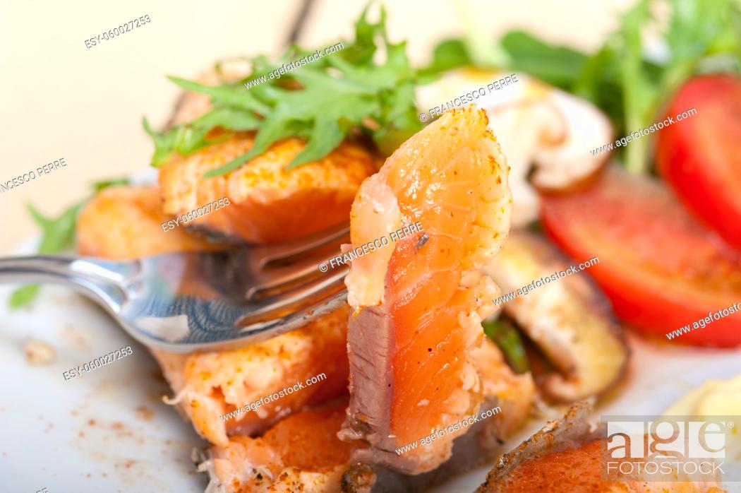 Stock Photo: grilled fresh samon filet with vegetables salad tomato arugula mushroomsand paprika on top.