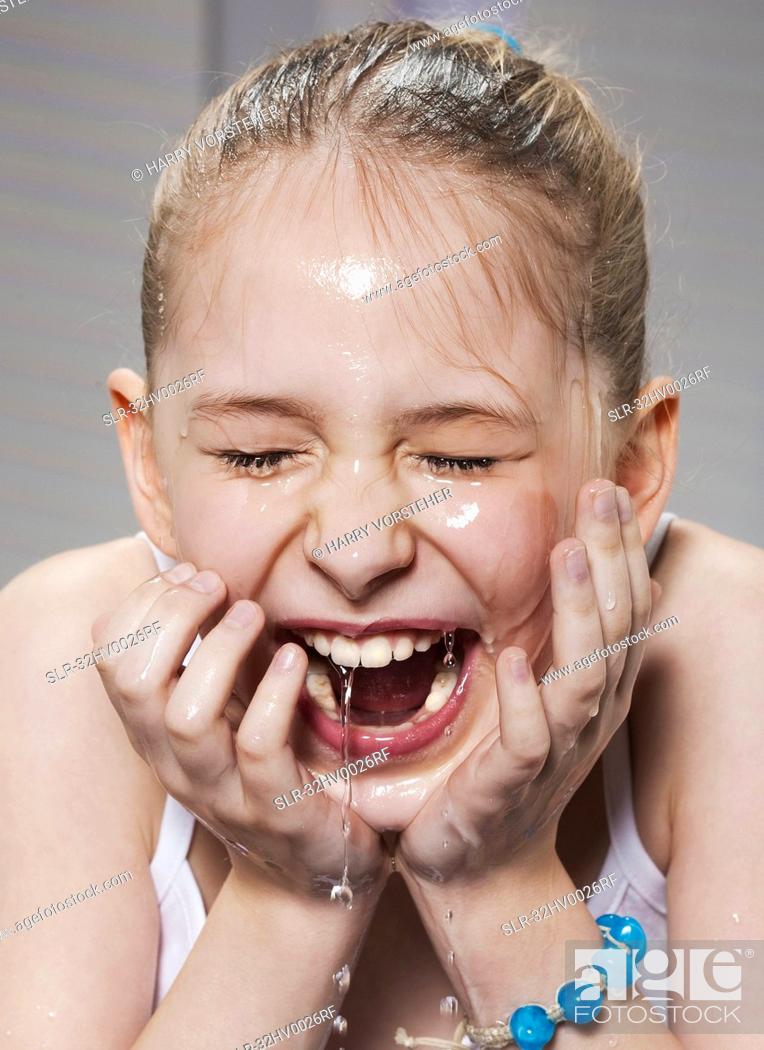 Stock Photo: Laughing girl washing her face.