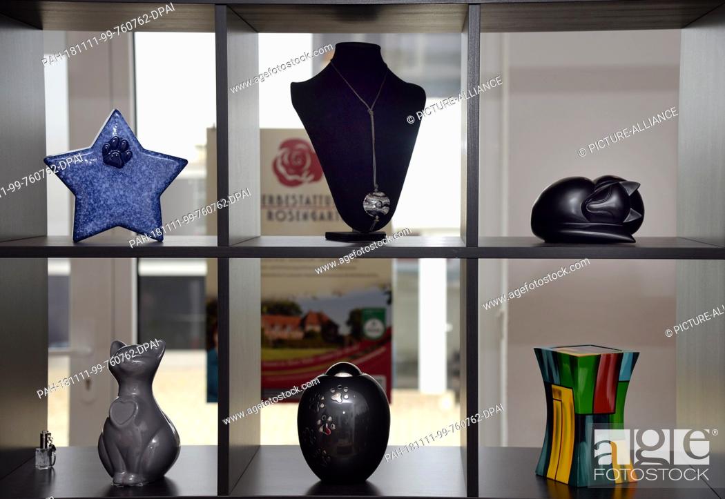 Stock Photo: 07 November 2018, Rhineland-Palatinate, Trier: Urns for pets are available in various forms in the Trier branch of the animal burial Rosenheim.