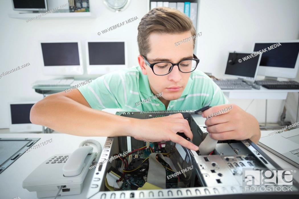 Stock Photo: Technician working on broken computer.