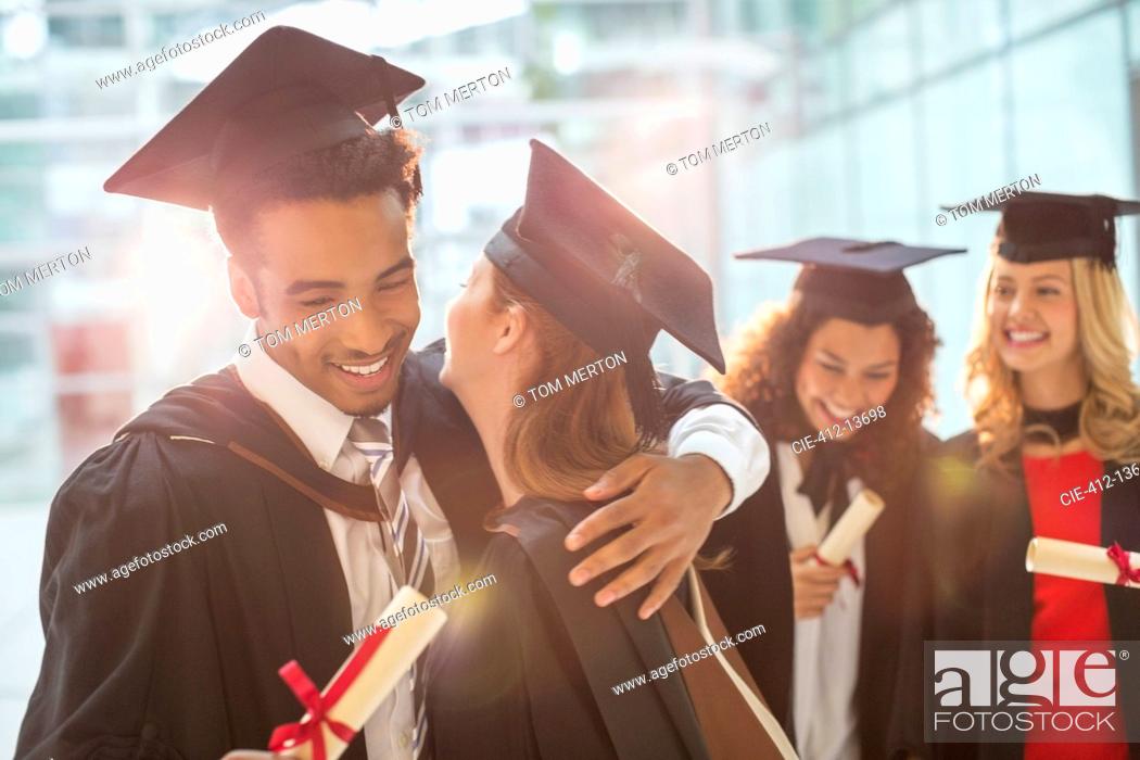 Stock Photo: Graduates hugging.
