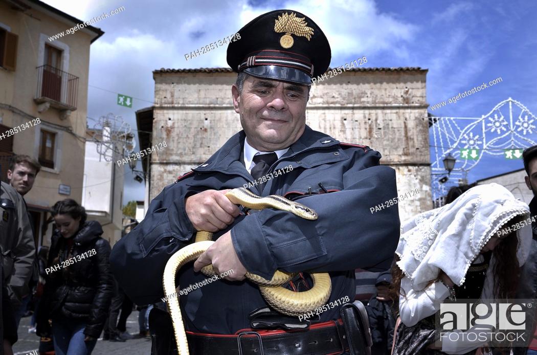 Stock Photo: After two years of interruption due to the pandemic, the procession of snakes in Cocullo takes place on 1 May 2022.the police officer of Cocullo with snakes in.