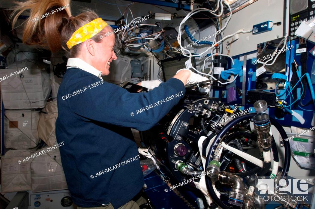 Stock Photo: NASA astronaut Karen Nyberg, Expedition 37 flight engineer, works on the Multi-User Droplet Combustion Apparatus (MDCA) Chamber Insert Assembly (CIA) at a.