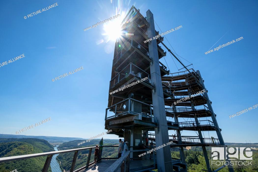 Stock Photo: 03 August 2022, Saarland, Orscholz: The sun is above the Cloef observation tower near Orscholz. Around 35 degrees Celsius are reported for today in the Saarland.