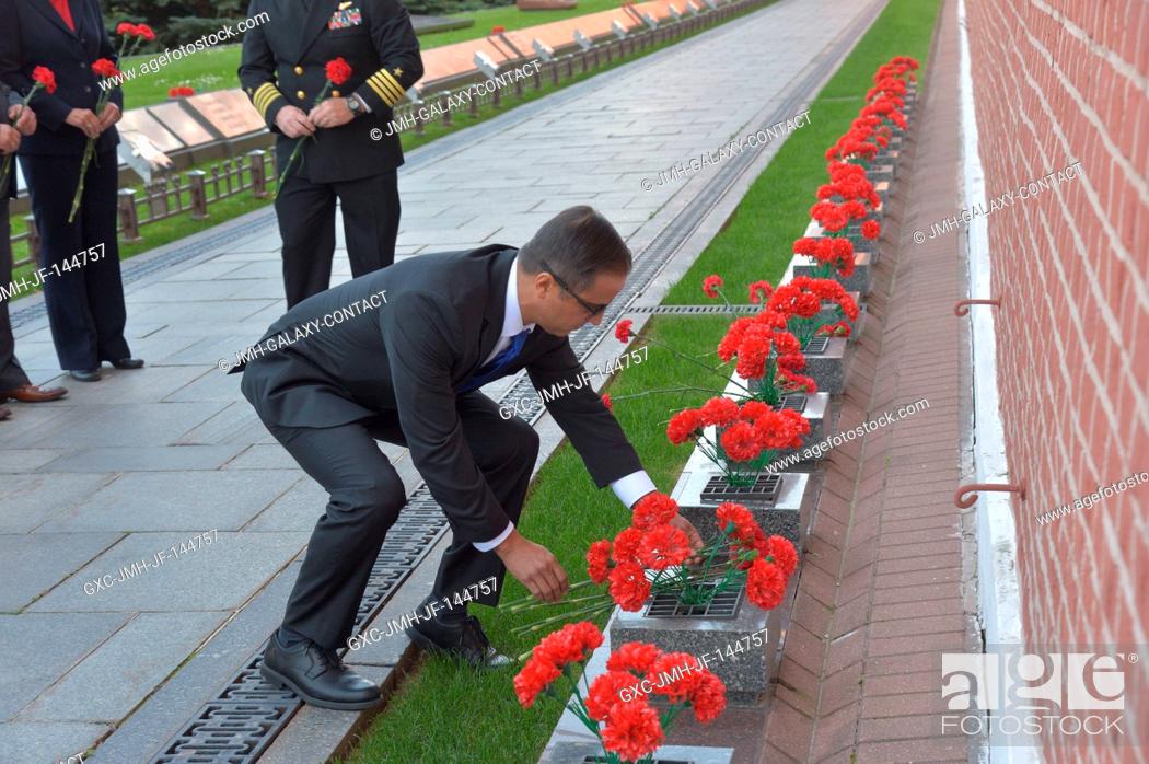 Stock Photo: Prime Expedition 53-54 crewmember and NASA astronaut Joe Acaba lays flowers at the Kremlin Wall in Moscow where Russian space icons are interred as part of.