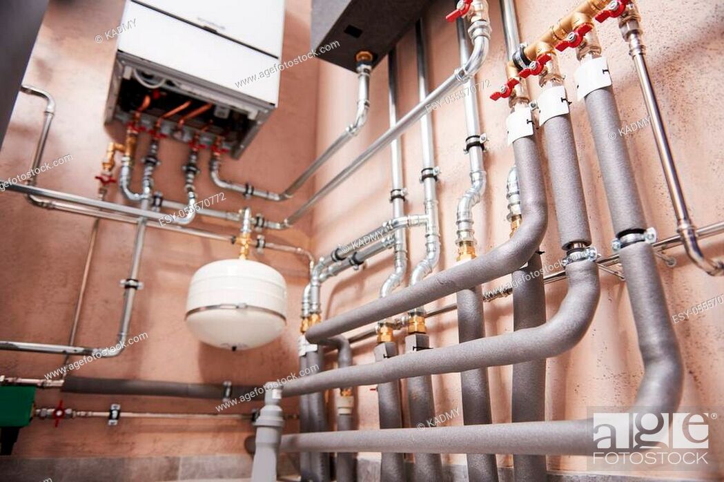 Stock Photo: private house autonomous heating system in boiler room. Hot water heating equipment. Plumbing services.