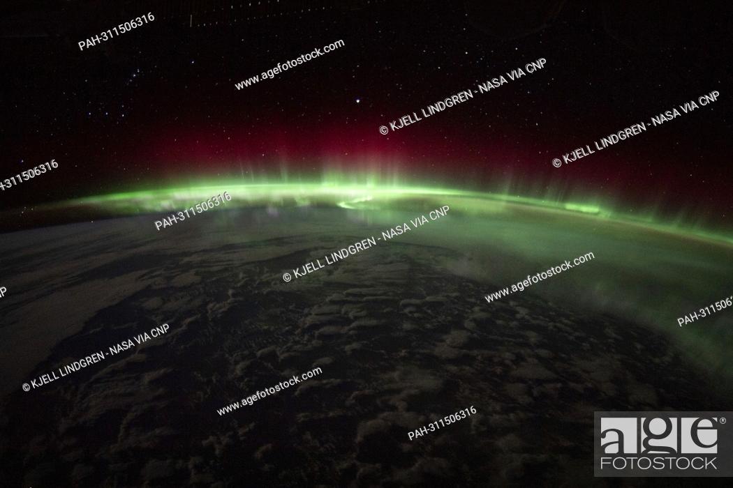 Stock Photo: An aurora crowns the Earth beneath a starry sky in this night time photograph from the International Space Station as it orbited 270 miles above the Indian.