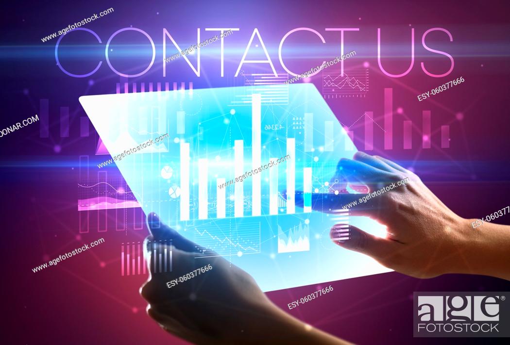 Stock Photo: Hand holding futuristic tablet with CONTACT US inscription above, modern business concept.