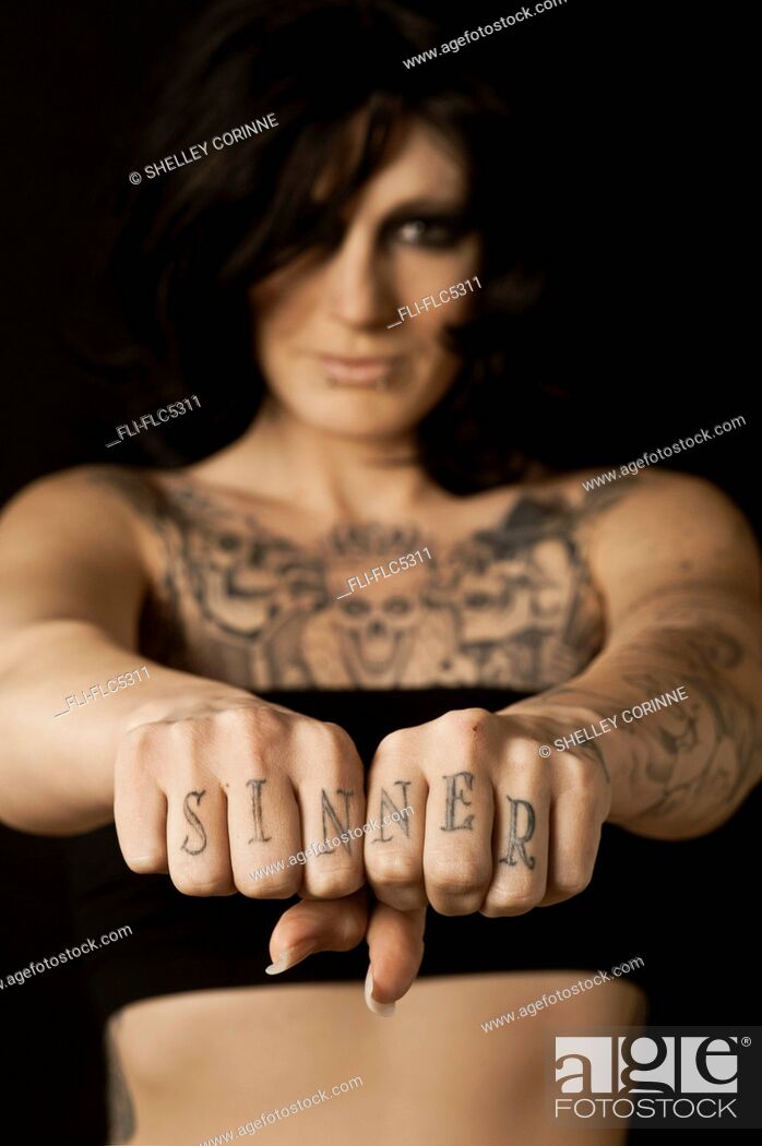 Women with Tattoos on Chest and 'Sinner' on Knuckles, Stock Photo, Picture  And Rights Managed Image. Pic. FLI-FLC5311 | agefotostock