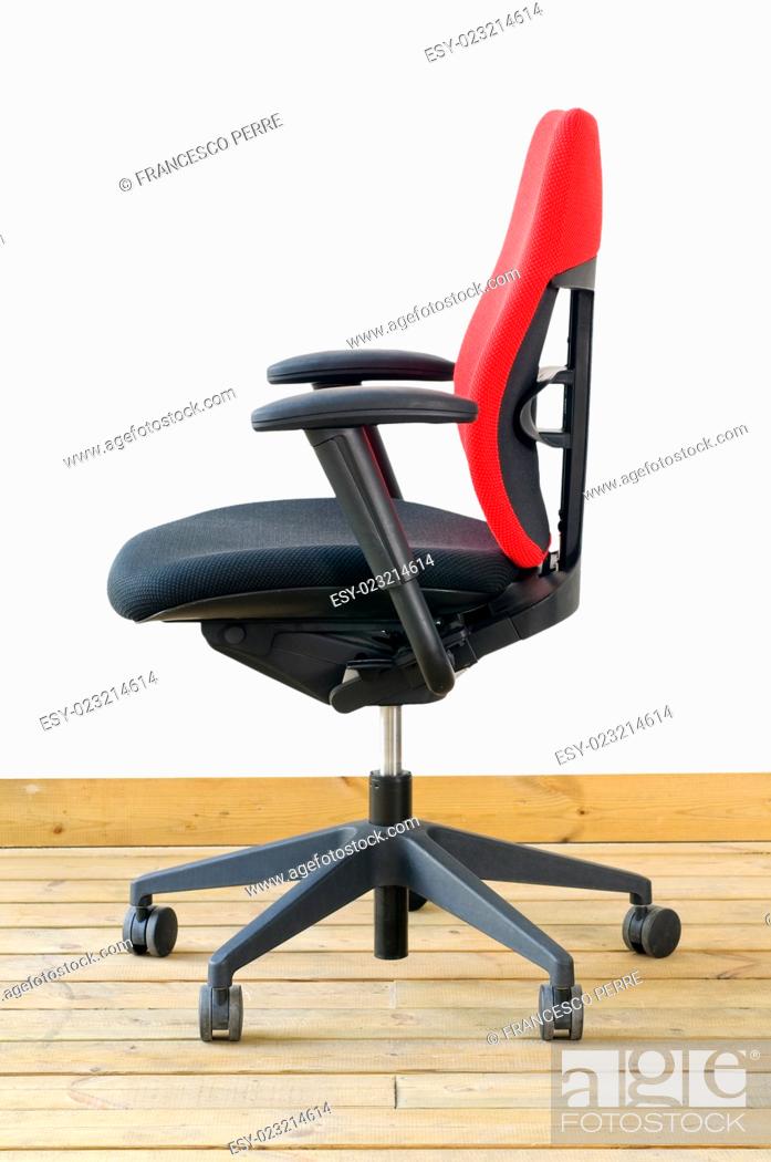 Stock Photo: modern red office chair on wood floor over white background.