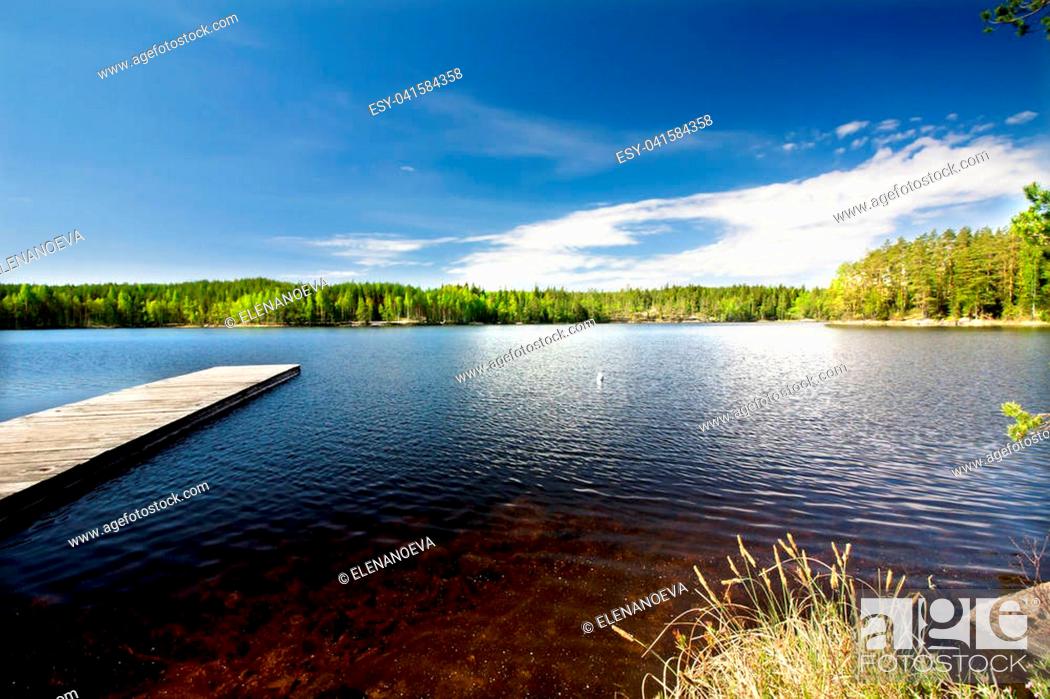 Stock Photo: Wooden pier on beautiful lake in the national park Repovesi, Finland, South Karelia.