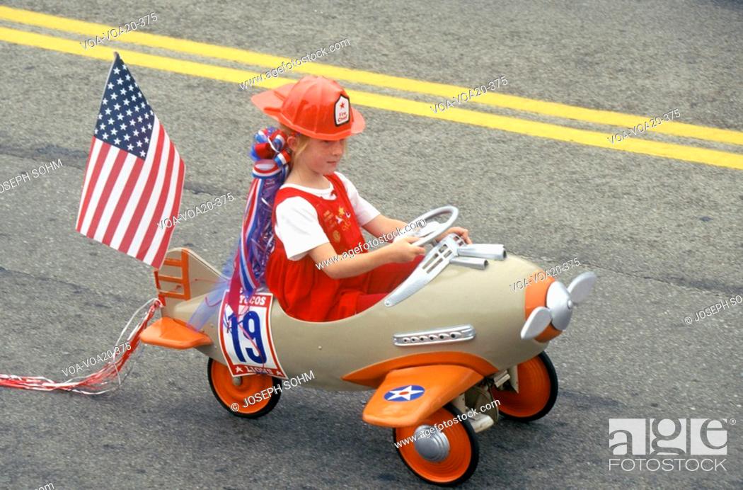 Stock Photo: Girl in Toy Airplane in July 4th Parade, Cayucos, California.