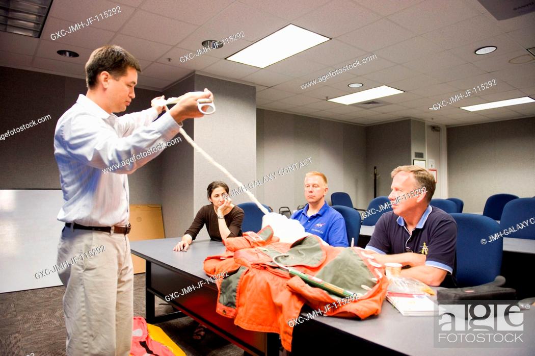 Stock Photo: Crew trainer Adam Flagan (standing) briefs STS-133 crew members during a classroom session of water survival training at NASA's Johnson Space Center.