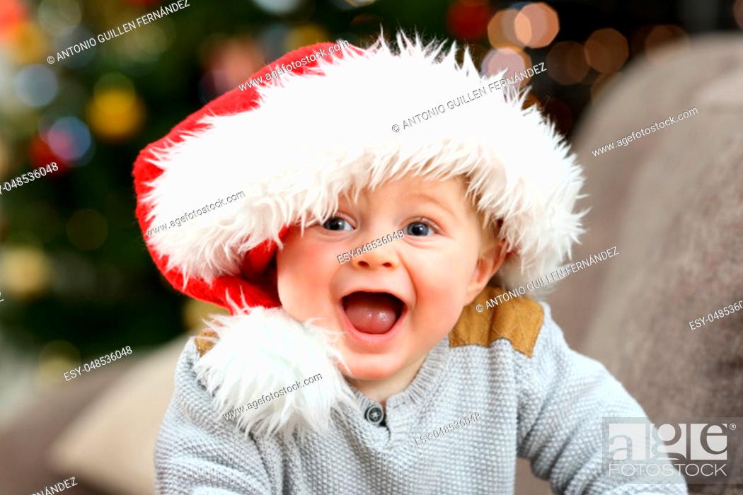 Stock Photo: Excited baby looking at you in christmas.