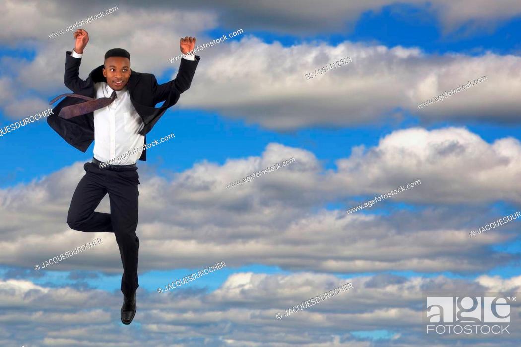 Stock Photo: young man suit and tie jump in clouds blue sky businessman jumping in the air energetic lifestyle success.