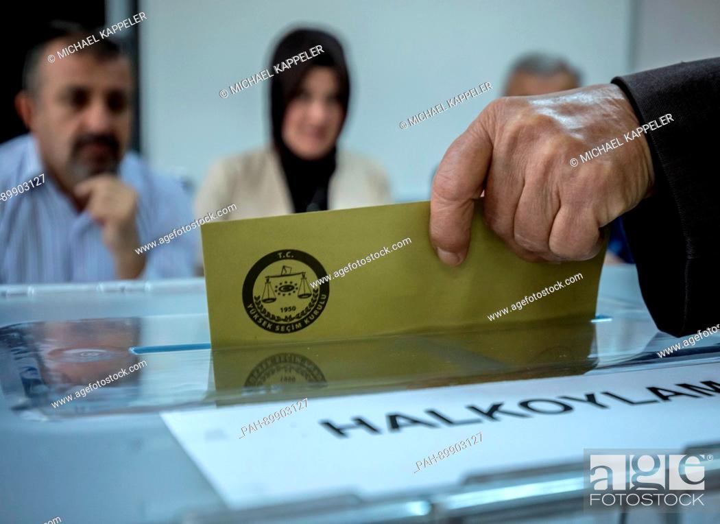 Stock Photo: dpatop - A man casts his vote at a polling station in Istambul, Turkey, 16 April 2017. Turkish citizens are voting on a constitutional amendment towards the.