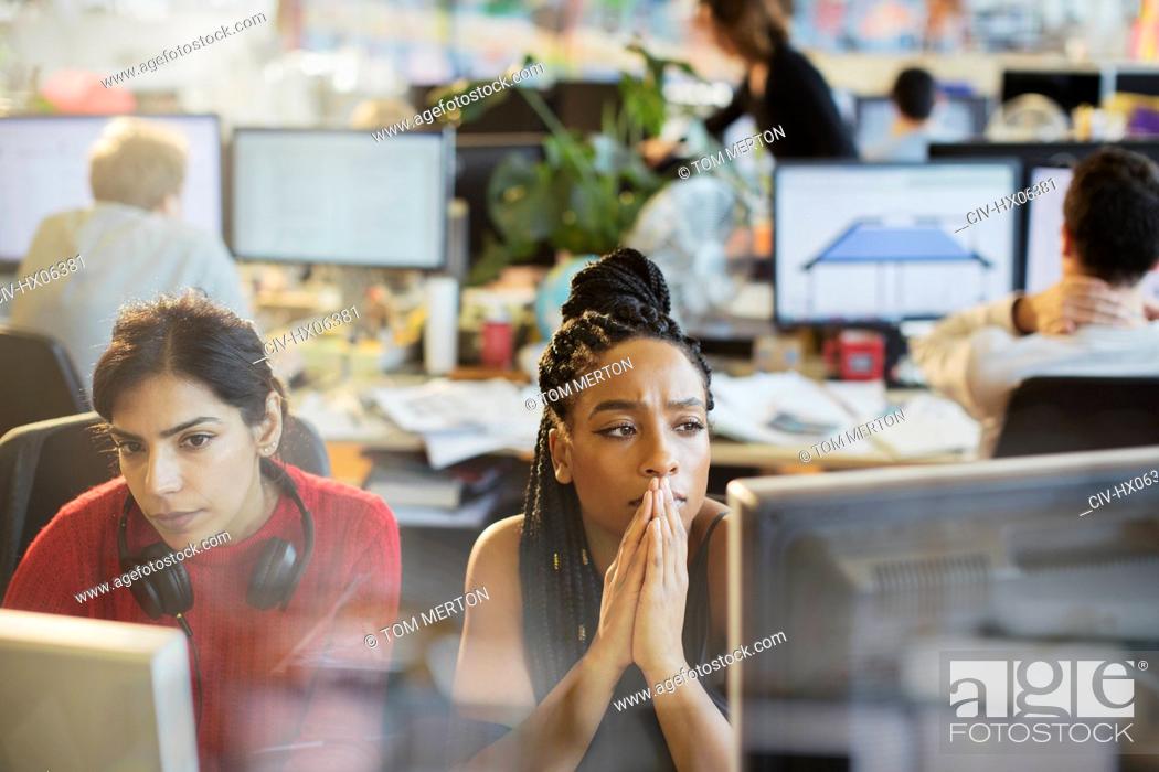 Stock Photo: Serious businesswomen working at computers in office.