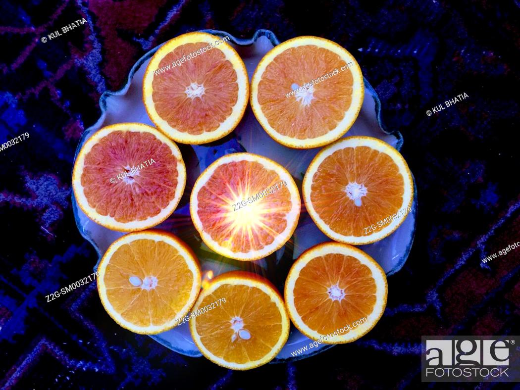 Stock Photo: Juicy grapefruit and orange halves arrainged in a circle. Citrus fruit, rich source of Vitamin C. Concepts: tropical sunshine, cherry, optimism.