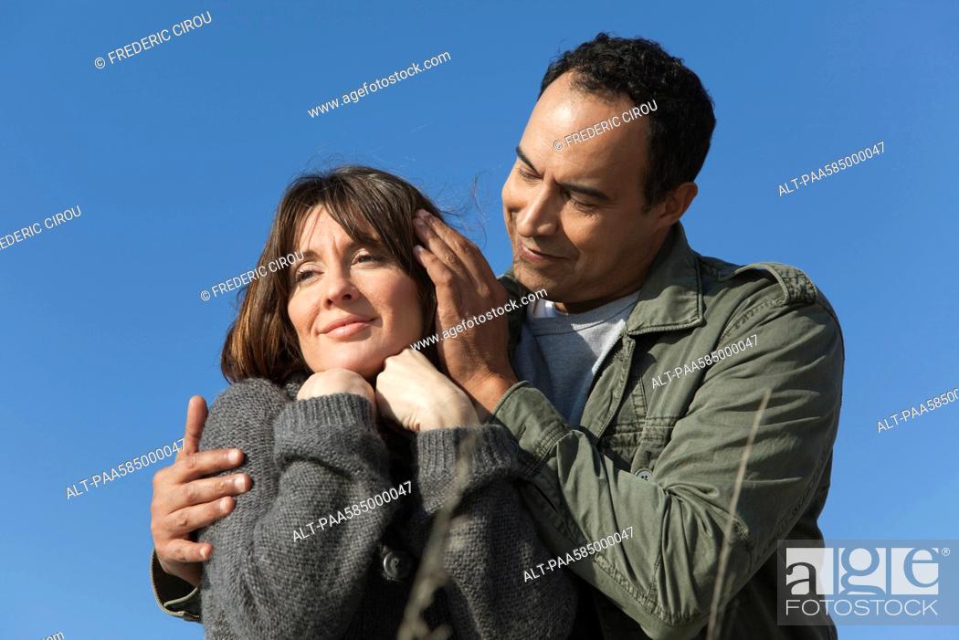 Mature couple relaxing together outdoors, man caressing woman's hair, Stock  Photo, Picture And Royalty Free Image. Pic. ALT-PAA585000047 | agefotostock