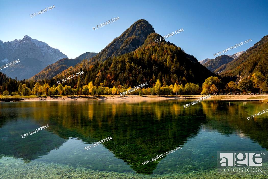 Stock Photo: A view of Lake Jasna with forest and mountain landscape in beautiful autumn colors.