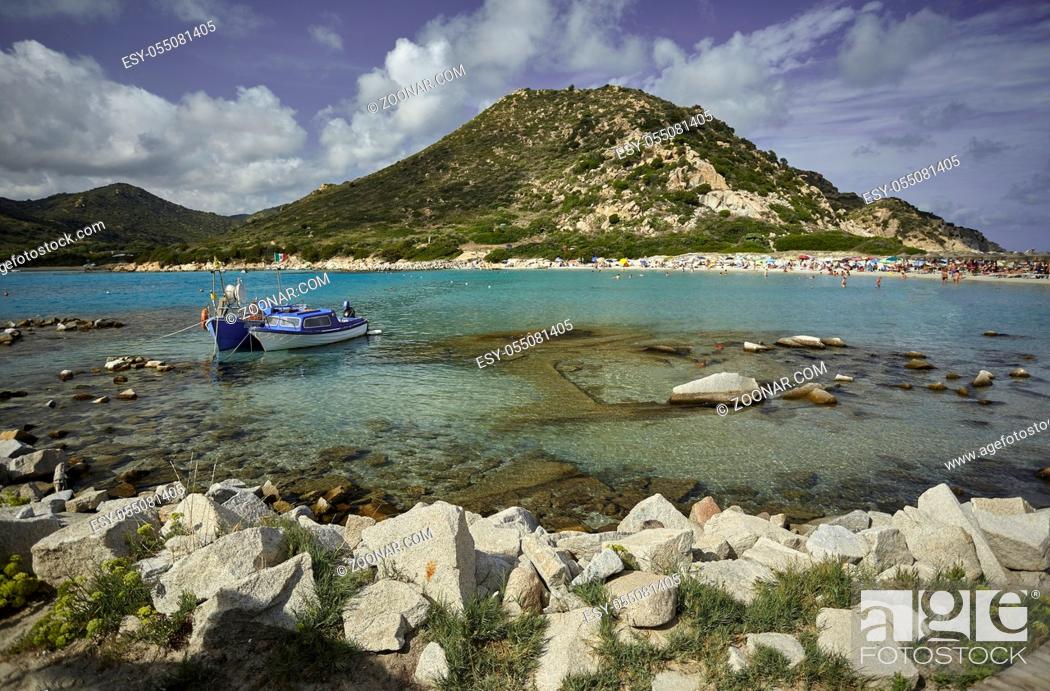 Stock Photo: Beautiful view of Punta Molentis, a natural beach on the southern coast of Sardinia with a couple of small fishing boats moored on the shore.