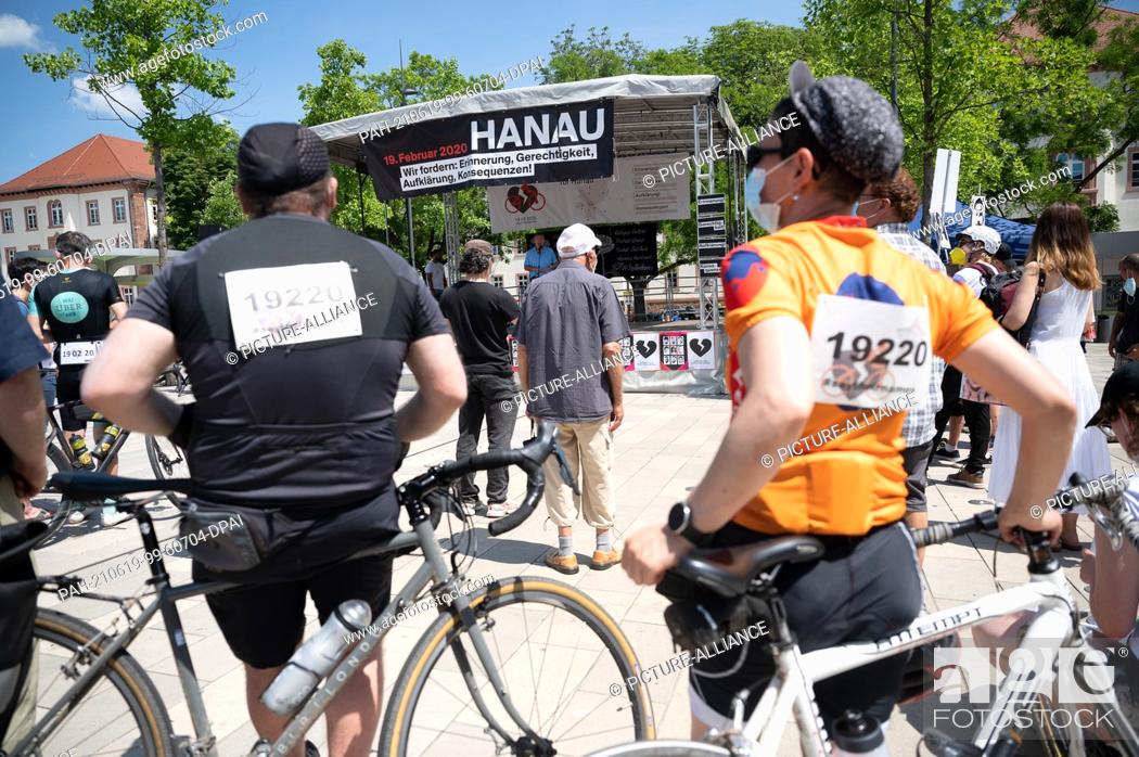 Stock Photo: 19 June 2021, Hessen, Hanau: Participants stand at the rally after the ""Star for Hanau"" bicycle ride in memory of the right-wing terrorist attack in Hanau.