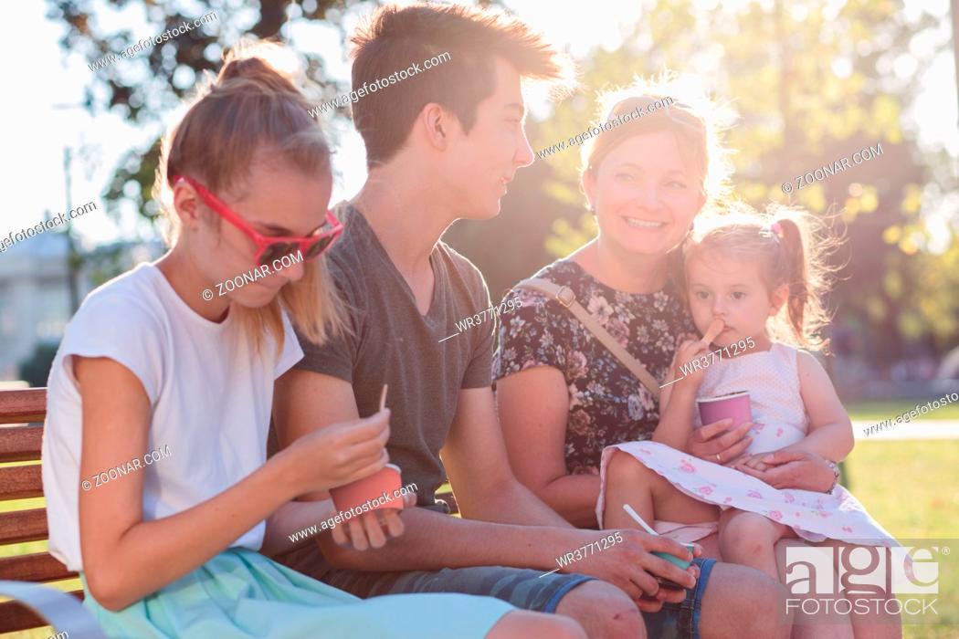 Stock Photo: Family spending time together in the city centre eating ice cream on a summer day.