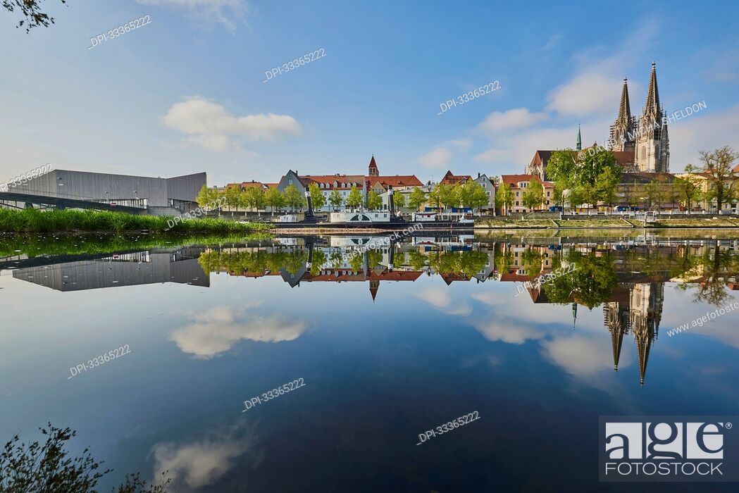 Stock Photo: Outlook over the Danube River with the old, Gothic St Peter's Cathedral on the right and the modern Museum of Bavarian History on the left.