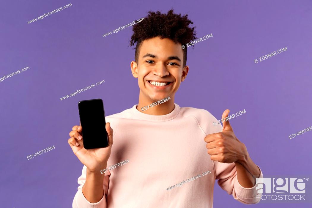 Stock Photo: Close-up portrait of cheerful, satisfied young male customer recommend buying subscribtion to game or app, learning leanguage via application mobile phone.