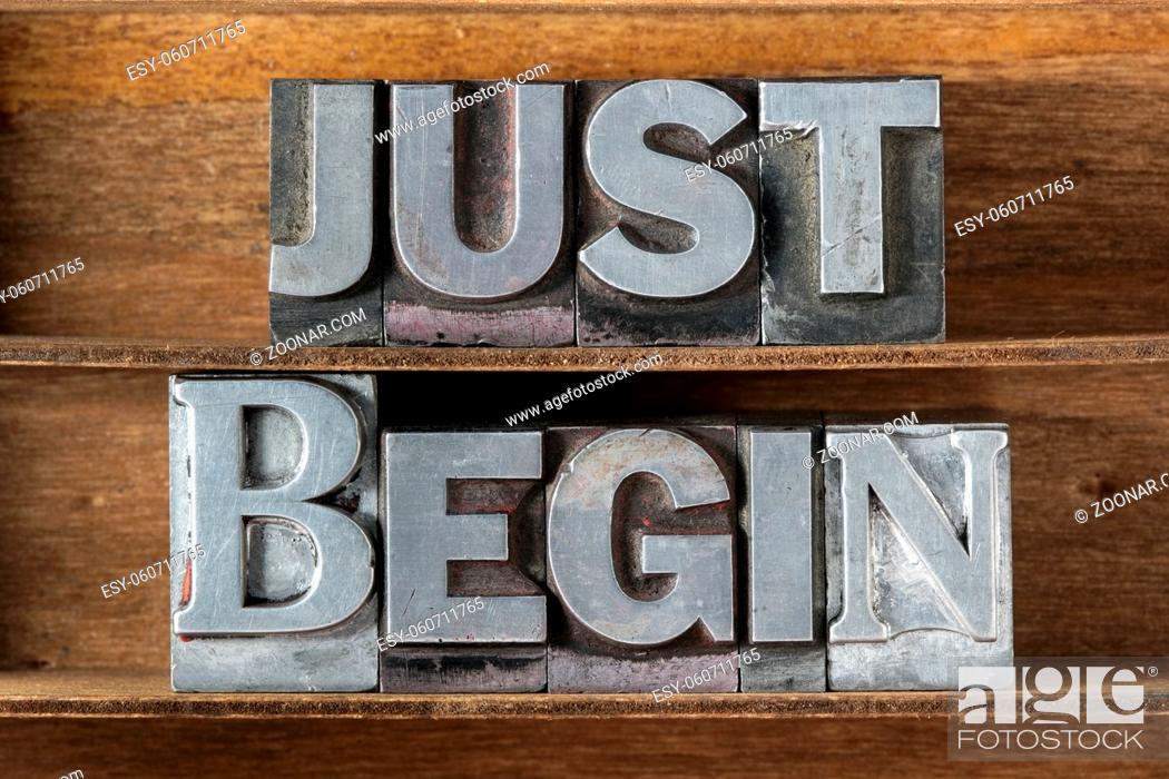 Stock Photo: just begin phrase made from metallic letterpress type on wooden tray.