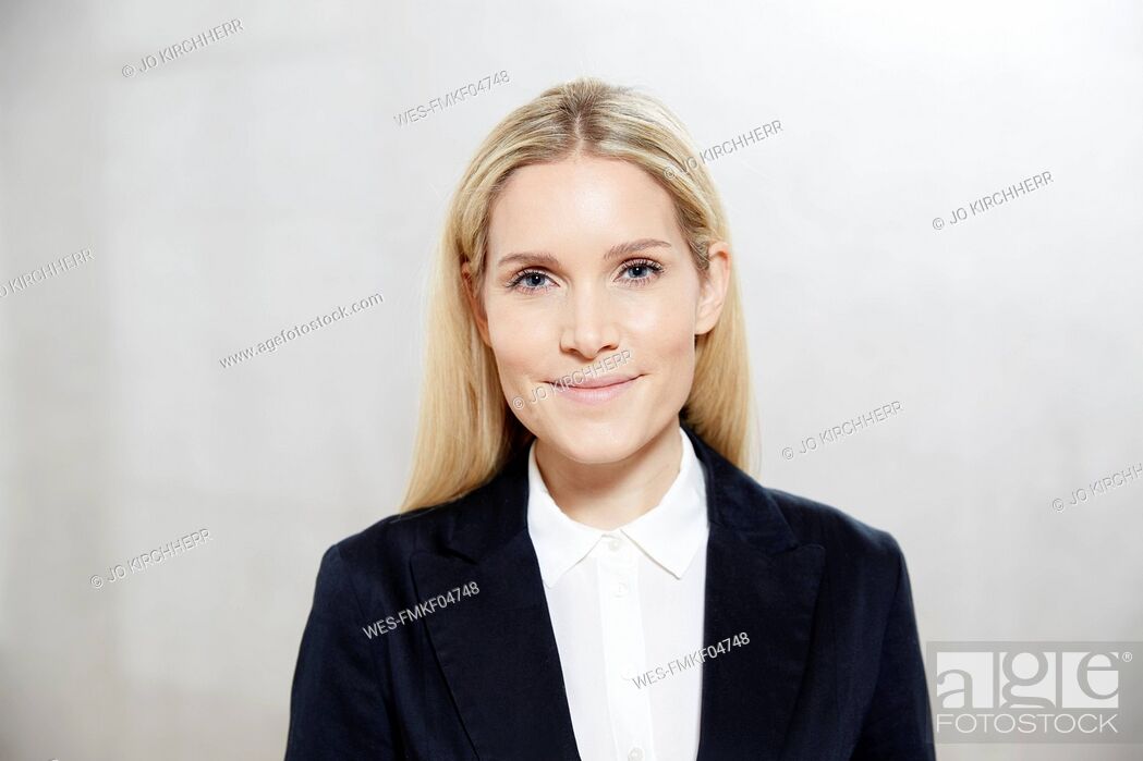 Stock Photo: Portrait of smiling blond businesswoman.