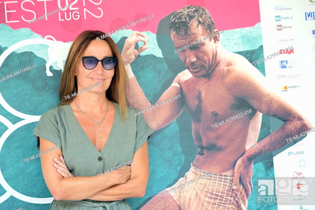 Stock Photo: Maria Sole Tognazzi posess with an image of her father the actor Ugo Tognazzi for the photocall of 'Dillo come una donna' at the 68th Taormina Film Festival.