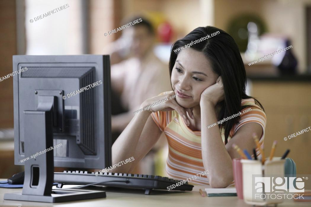 Stock Photo: Asian businesswoman at desk.